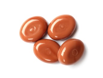 Photo of Tasty sweet caramel candies isolated on white, top view