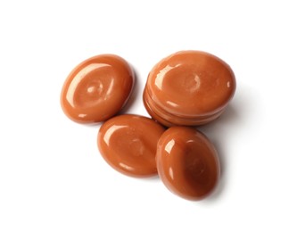 Photo of Tasty sweet caramel candies isolated on white, top view