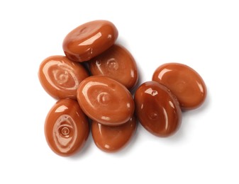 Photo of Tasty sweet caramel candies isolated on white, top view