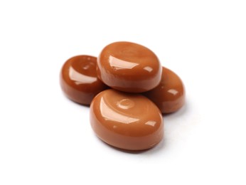 Photo of Tasty sweet caramel candies isolated on white