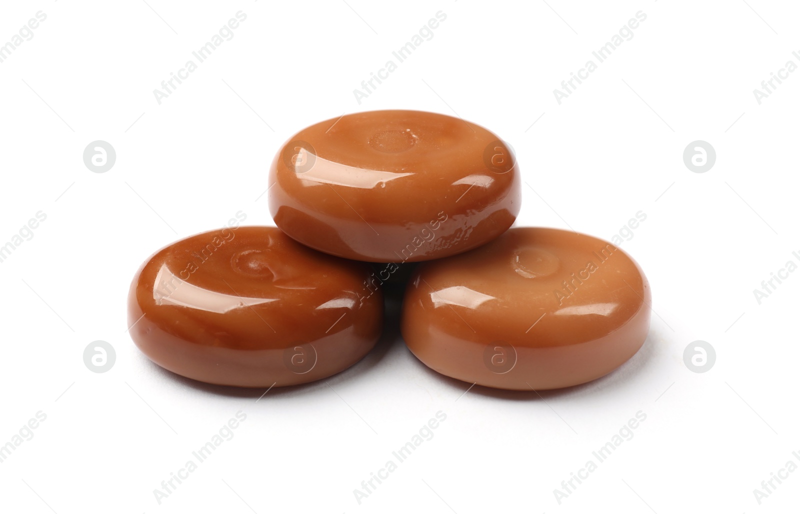 Photo of Tasty sweet caramel candies isolated on white