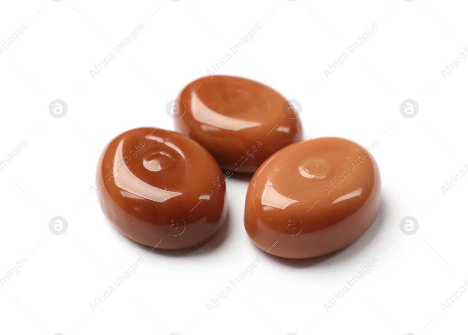 Photo of Tasty sweet caramel candies isolated on white