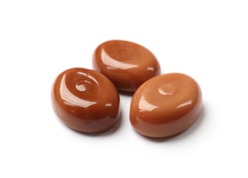 Photo of Tasty sweet caramel candies isolated on white
