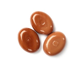 Photo of Tasty sweet caramel candies isolated on white, top view