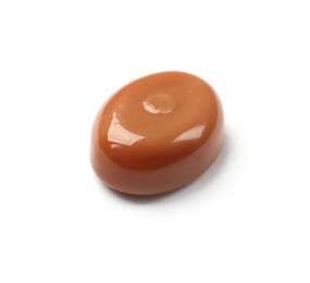 Photo of One tasty sweet caramel candy isolated on white