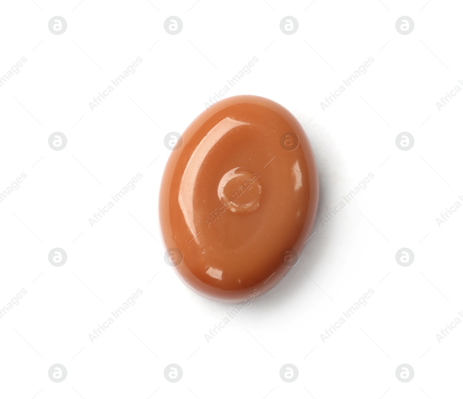 Photo of One tasty sweet caramel candy isolated on white, top view