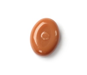 Photo of One tasty sweet caramel candy isolated on white, top view