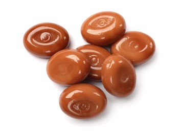 Photo of Tasty sweet caramel candies isolated on white, top view