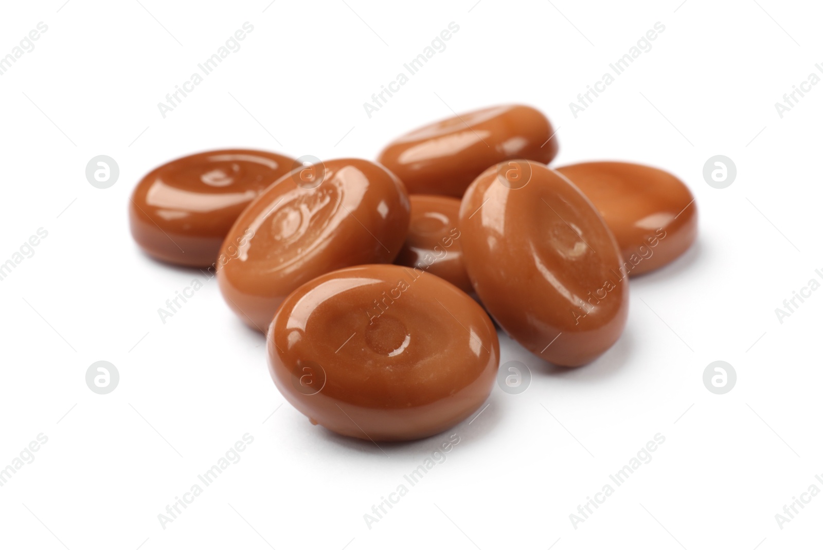 Tasty sweet caramel candies isolated on white Photo of Tasty sweet caramel candies isolated on white
