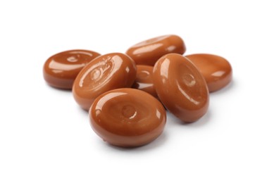 Photo of Tasty sweet caramel candies isolated on white