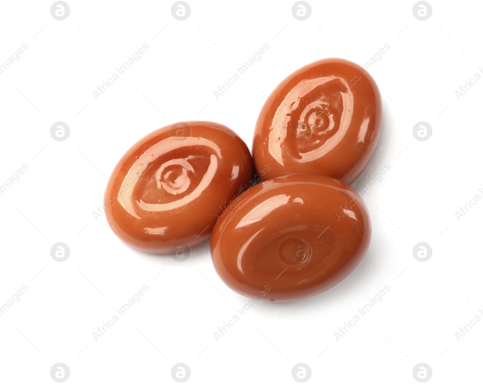 Tasty sweet caramel candies isolated on white, top view Photo of Tasty sweet caramel candies isolated on white, top view