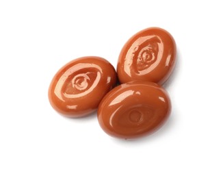 Photo of Tasty sweet caramel candies isolated on white, top view