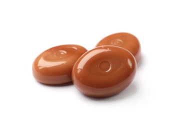 Photo of Tasty sweet caramel candies isolated on white