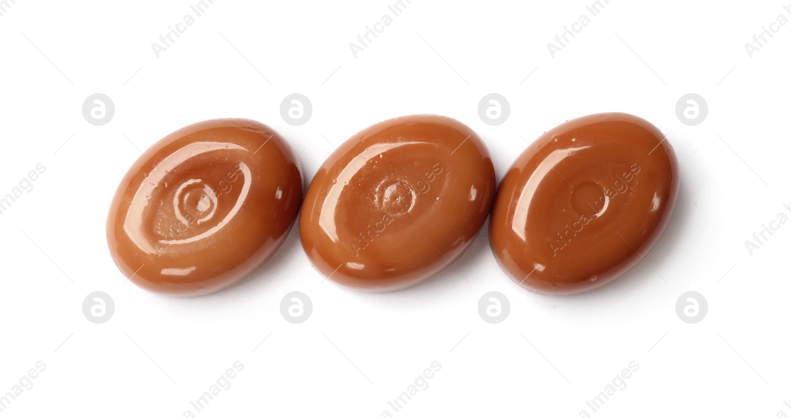 Tasty sweet caramel candies isolated on white, top view Photo of Tasty sweet caramel candies isolated on white, top view
