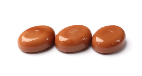 Photo of Tasty sweet caramel candies isolated on white