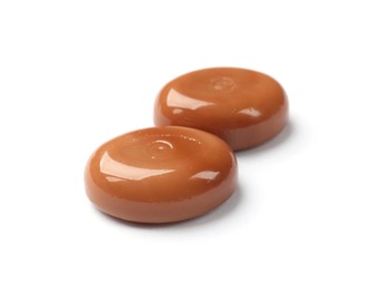 Photo of Tasty sweet caramel candies isolated on white