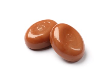 Photo of Tasty sweet caramel candies isolated on white