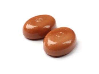 Photo of Tasty sweet caramel candies isolated on white