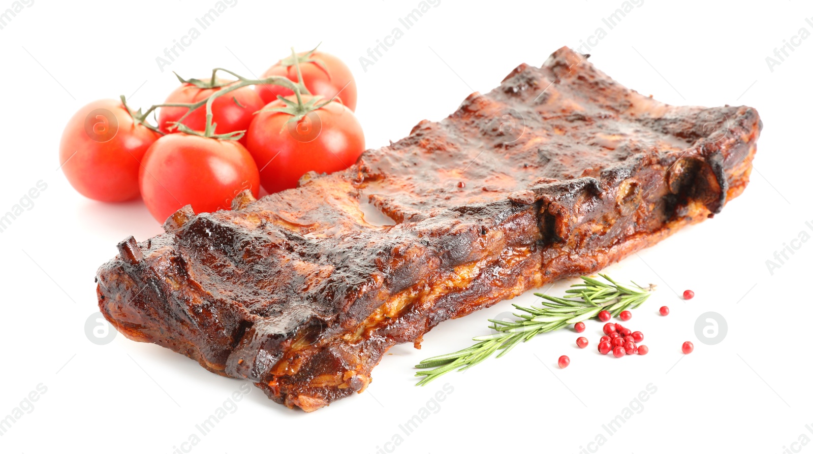 Tasty roasted pork ribs, tomatoes, spices and rosemary isolated on white Photo of Tasty roasted pork ribs, tomatoes, spices and rosemary isolated on white