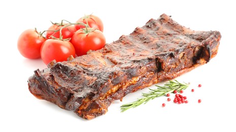 Photo of Tasty roasted pork ribs, tomatoes, spices and rosemary isolated on white