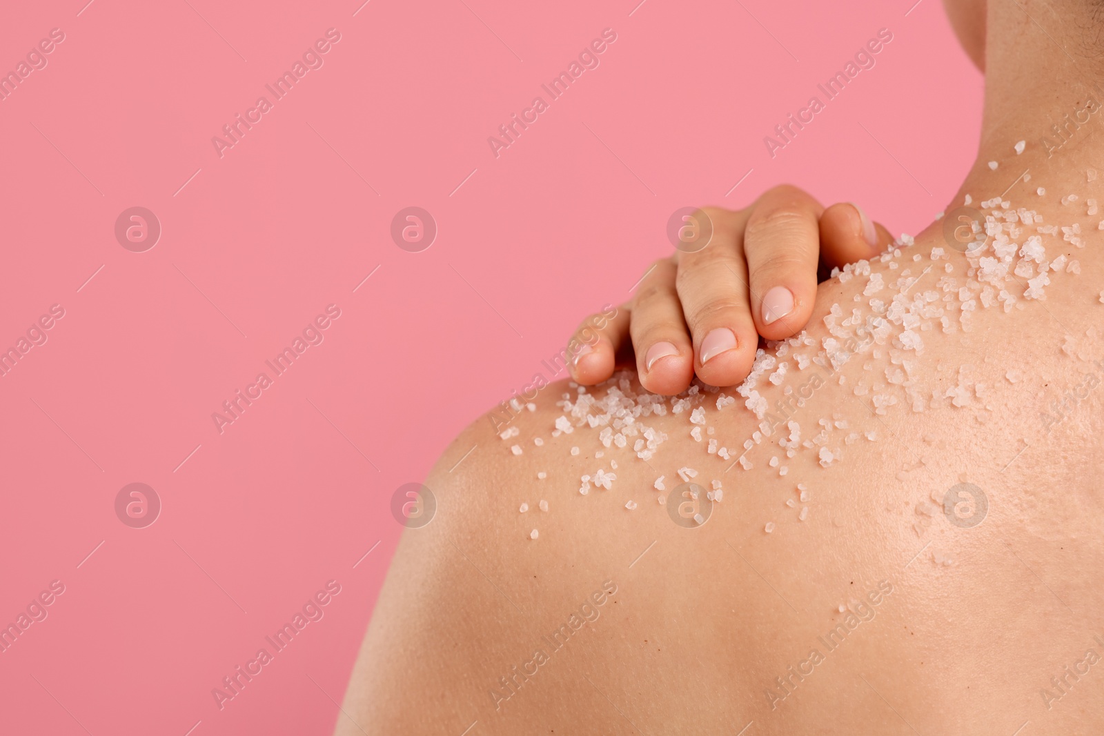 Woman with body scrub on her skin against pink background, closeup. Space for text Photo of Woman with body scrub on her skin against pink background, closeup. Space for text