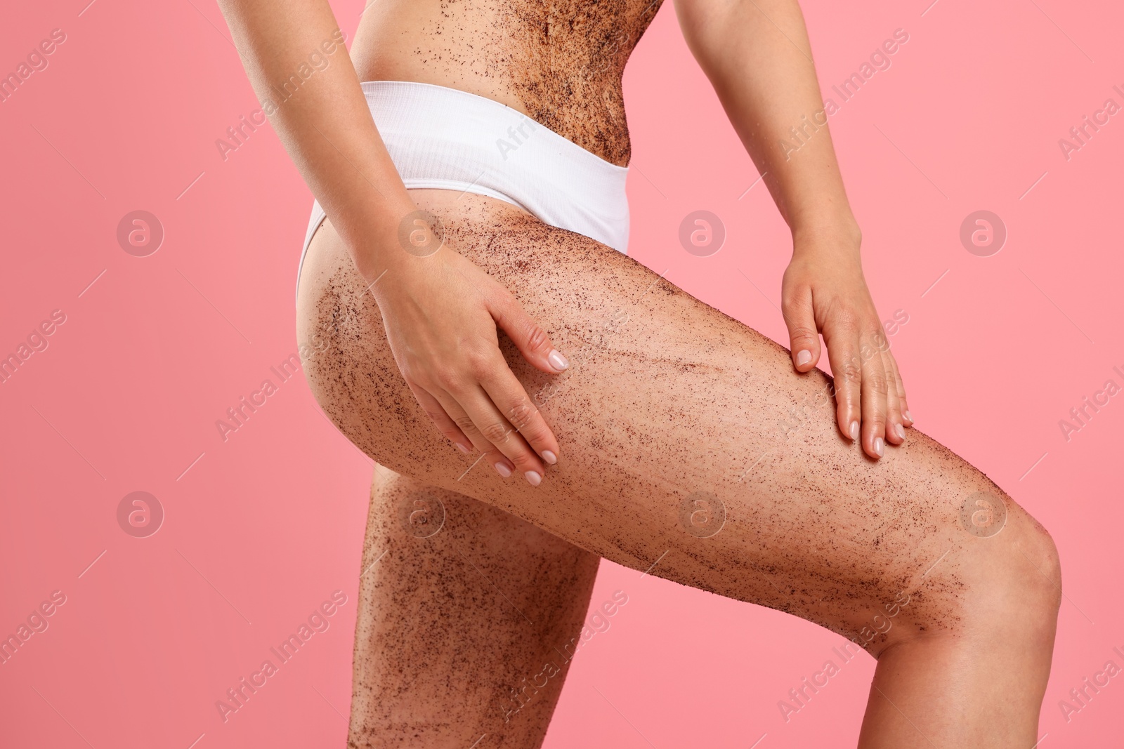 Woman with body scrub on her skin against pink background, closeup Photo of Woman with body scrub on her skin against pink background, closeup