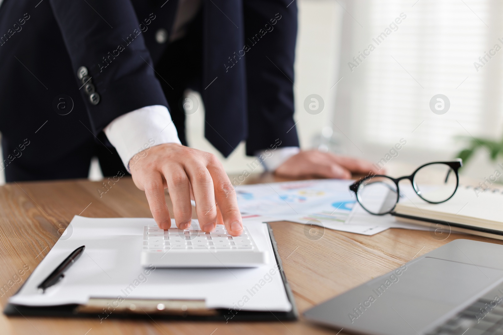 Professional banker working at desk in office, closeup Photo of Professional banker working at desk in office, closeup