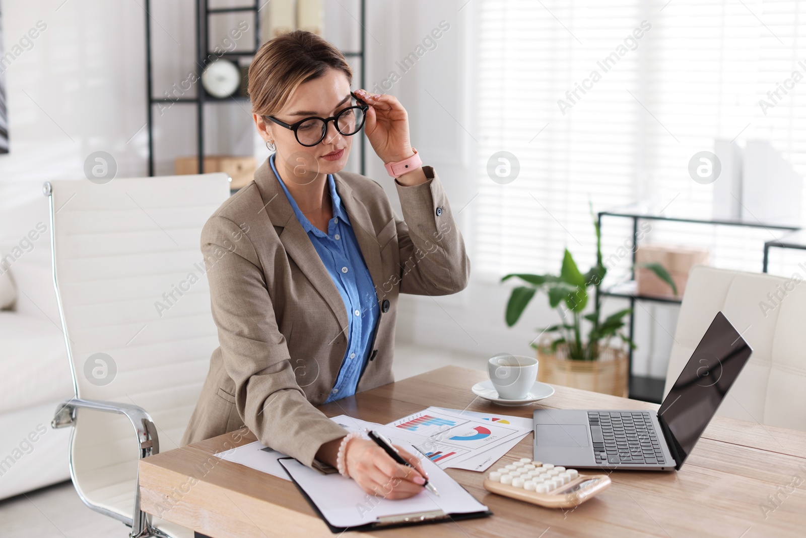 Professional banker working at desk in office Photo of Professional banker working at desk in office