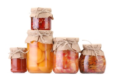 Photo of Many jars with different pickled products isolated on white