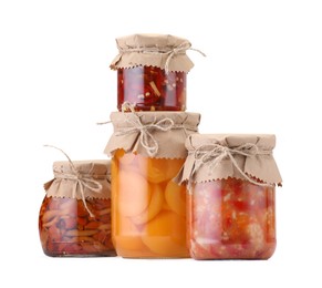 Photo of Many jars with different pickled products isolated on white