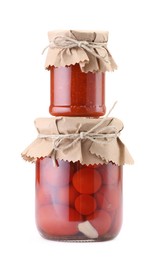 Photo of Jars with different pickled products isolated on white