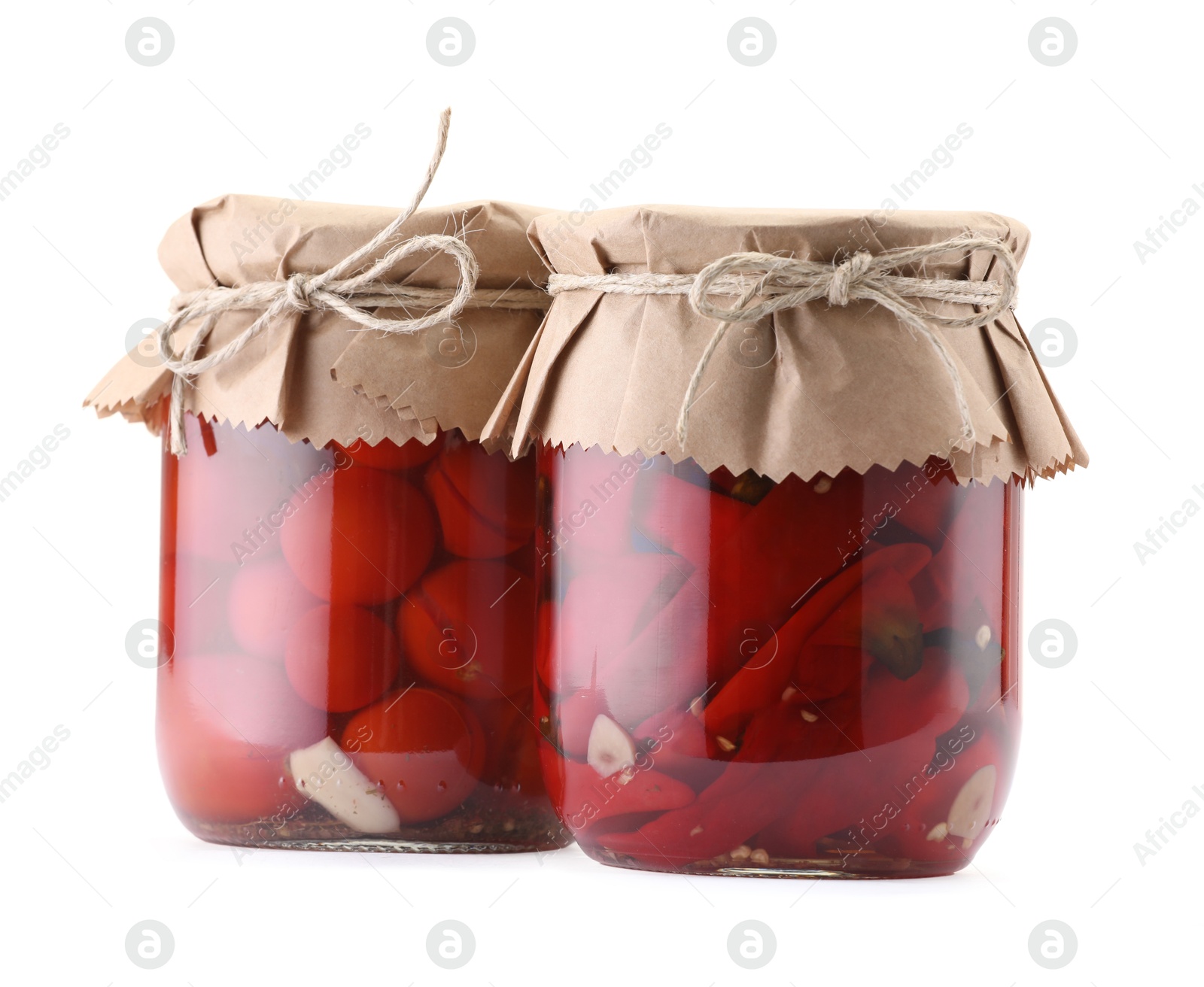 Jars with different pickled products isolated on white Photo of Jars with different pickled products isolated on white