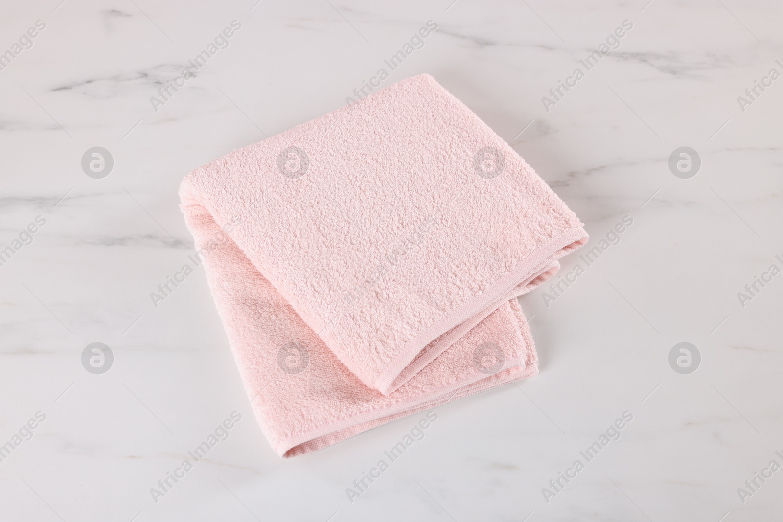 Clean towel on white marble table, above view Photo of Clean towel on white marble table, above view