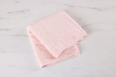 Photo of Clean towel on white marble table, above view