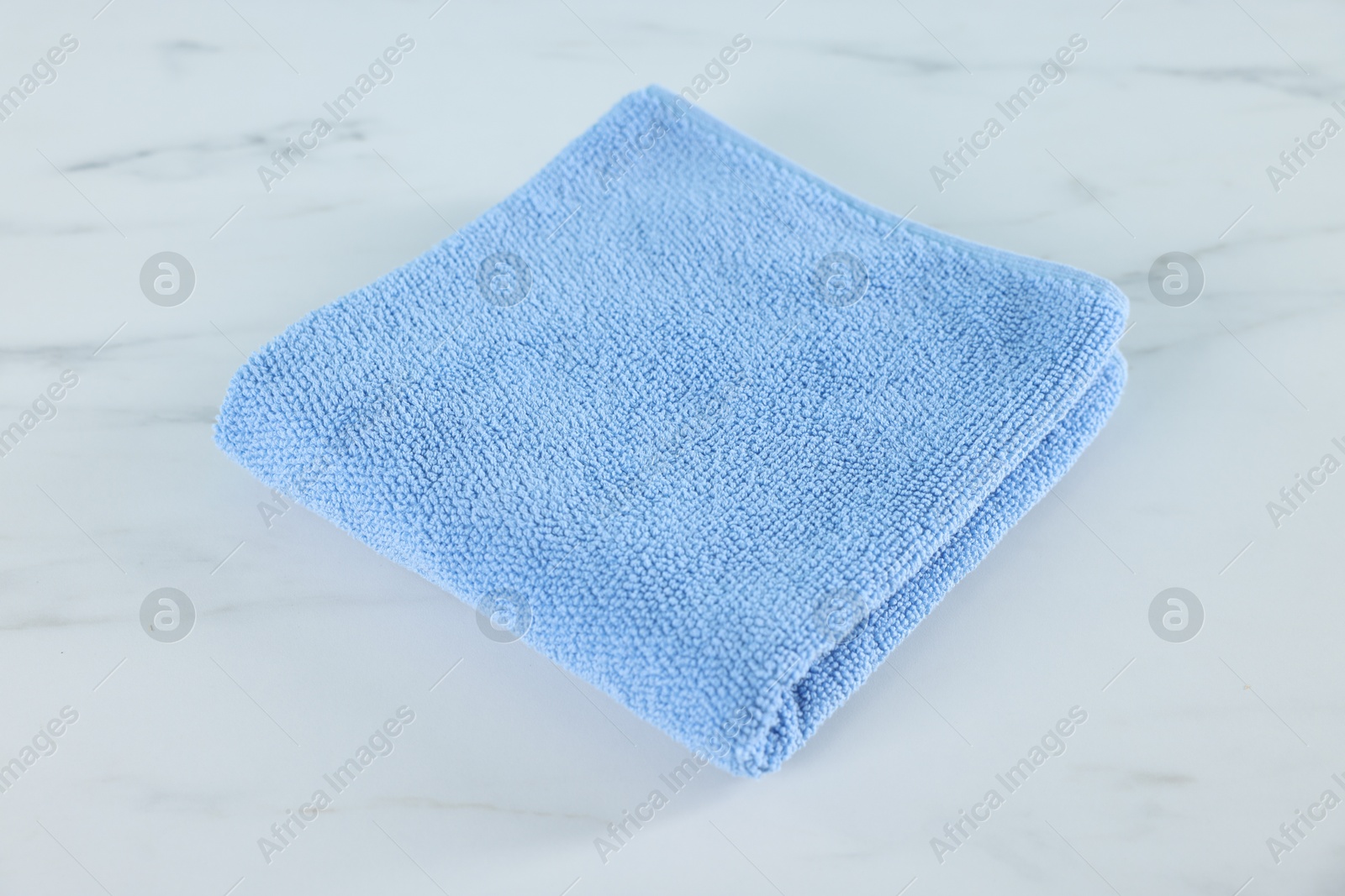 Clean towel on white marble table, closeup Photo of Clean towel on white marble table, closeup