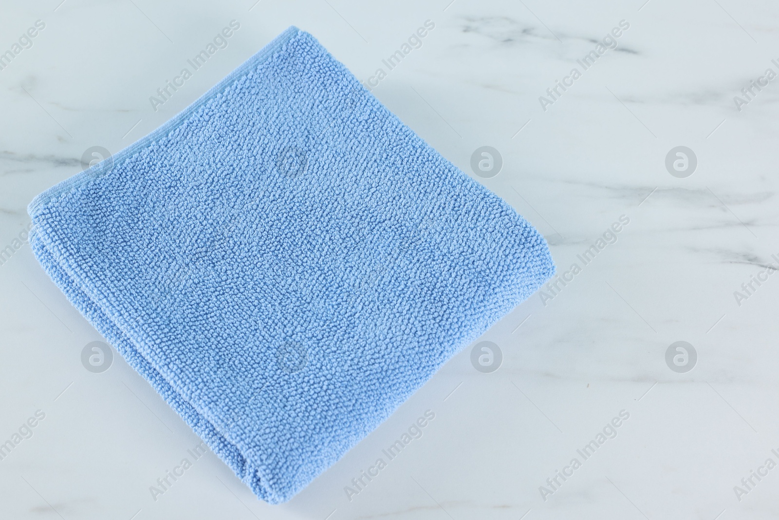 Clean towel on white marble table, above view Photo of Clean towel on white marble table, above view