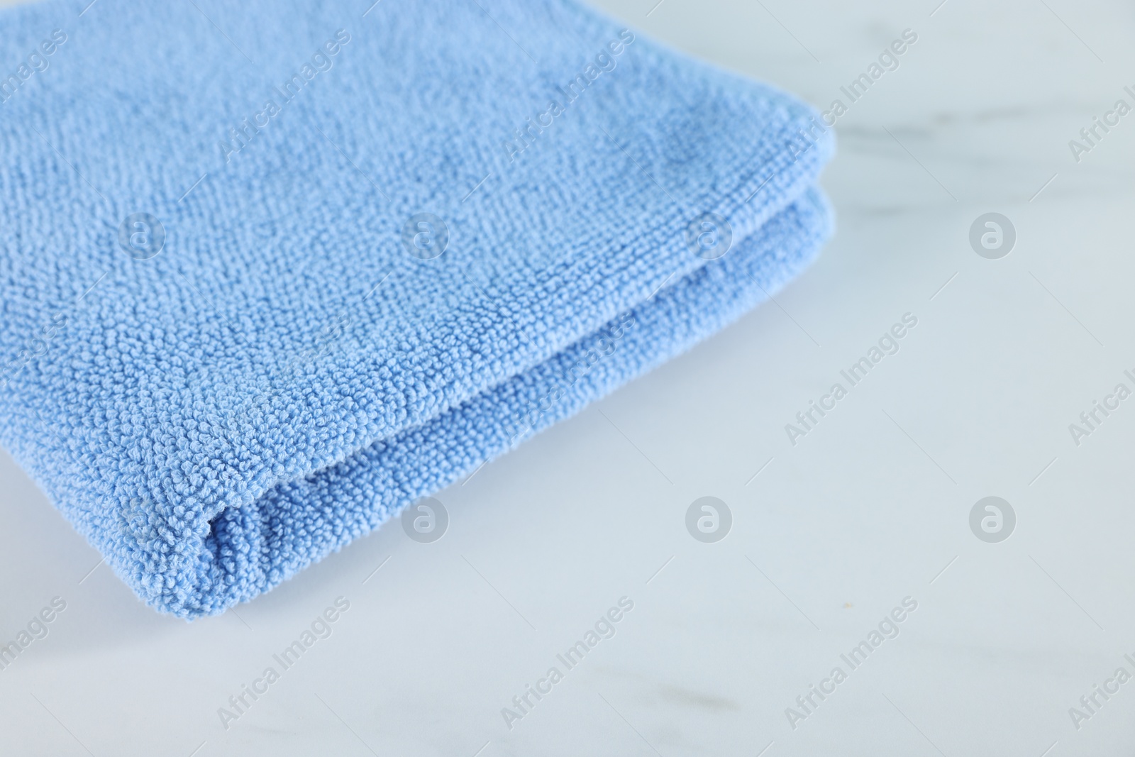 Clean towel on white marble table, closeup Photo of Clean towel on white marble table, closeup