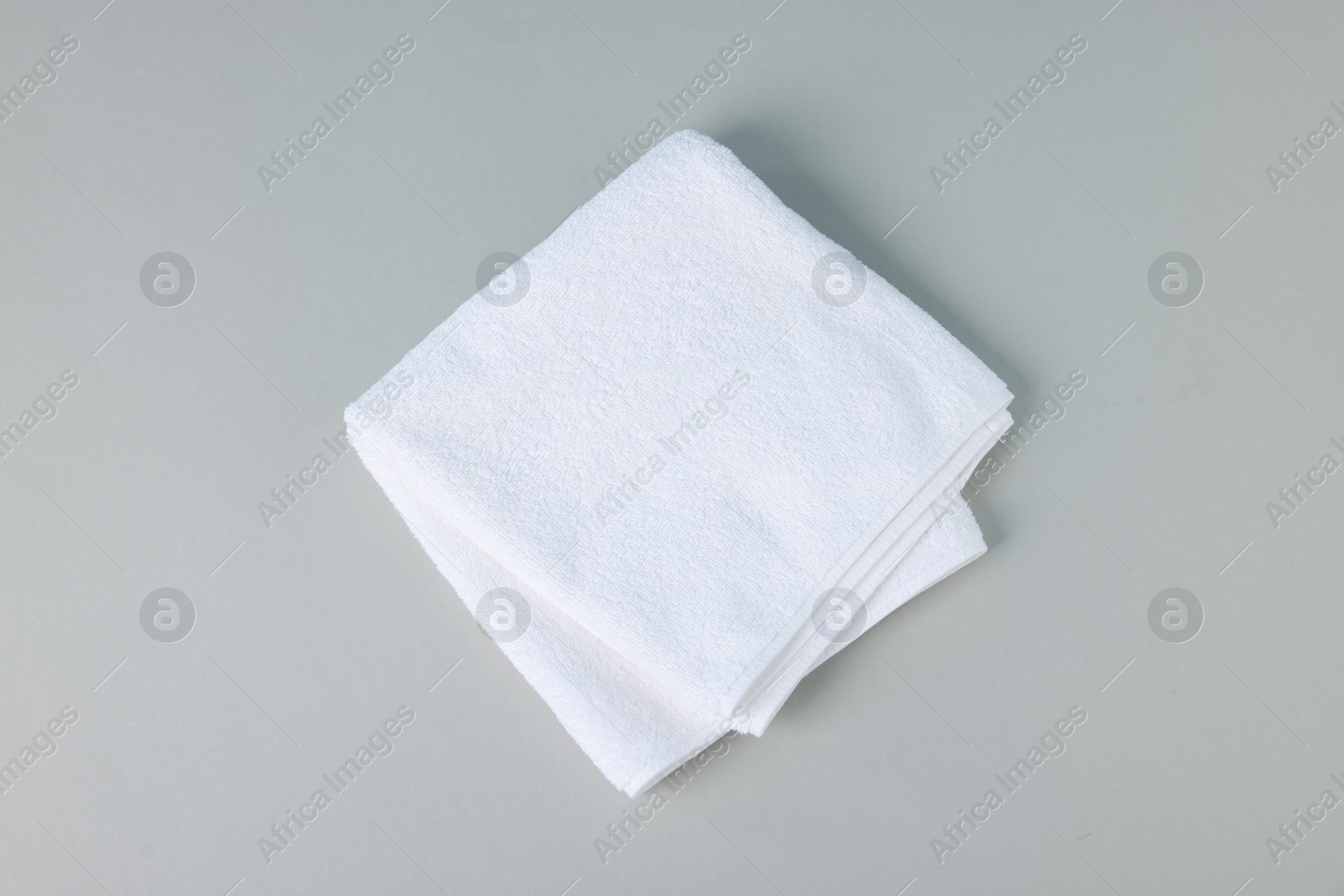 Clean towel on gray background, top view Photo of Clean towel on gray background, top view
