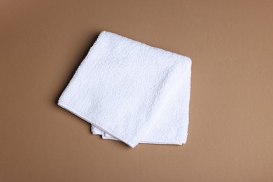 Photo of Clean towel on brown background, above view