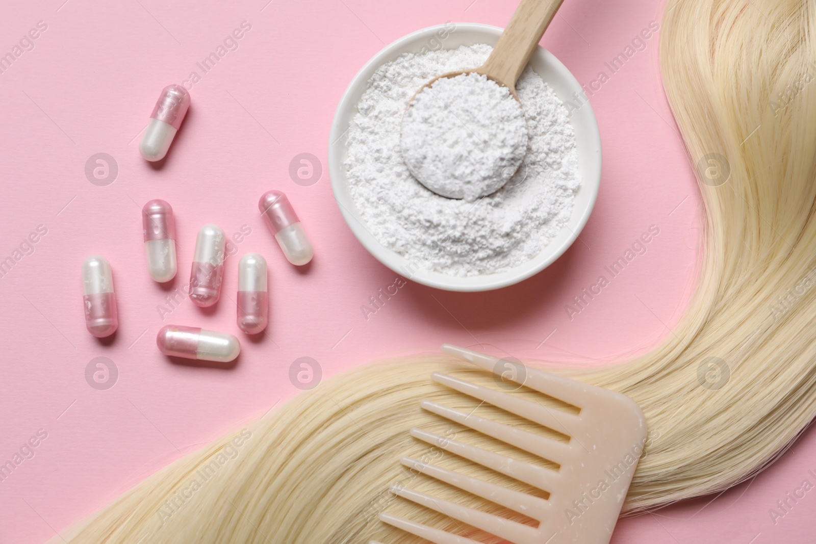 Collagen capsules, hair lock, powder and comb on pink background, flat lay Photo of Collagen capsules, hair lock, powder and comb on pink background, flat lay