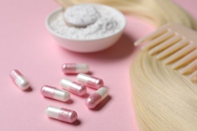 Photo of Collagen capsules, hair lock, powder and comb on pink background, closeup