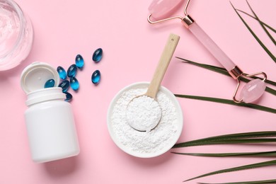 Photo of Collagen capsules, gel, powder and face roller on pink background, flat lay