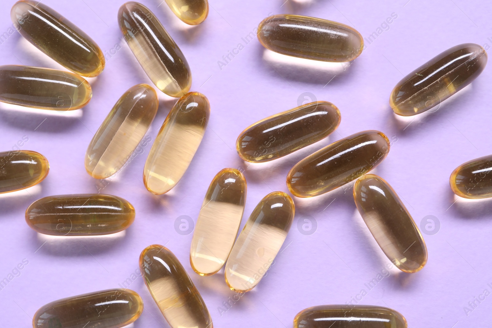 Collagen capsules on violet background, top view Photo of Collagen capsules on violet background, top view