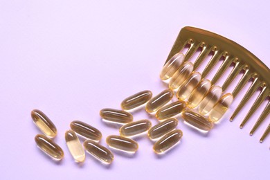 Photo of Collagen capsules and comb on violet background, flat lay. Space for text