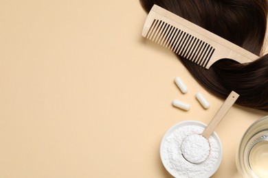 Photo of Collagen capsules, hair lock, powder, water and comb on beige background, flat lay. Space for text