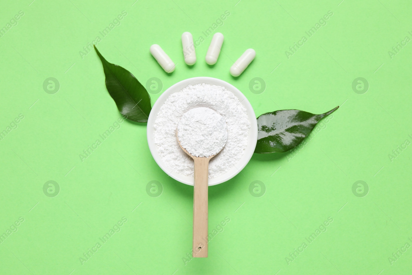 Flat lay composition with collagen capsules and powder on light green background Photo of Flat lay composition with collagen capsules and powder on light green background