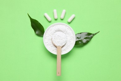Photo of Flat lay composition with collagen capsules and powder on light green background
