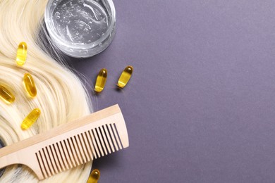 Photo of Collagen capsules, hair lock, gel and comb on violet background, flat lay. Space for text