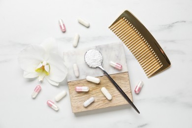 Photo of Collagen capsules, powder, comb and flower on white marble table, flat lay