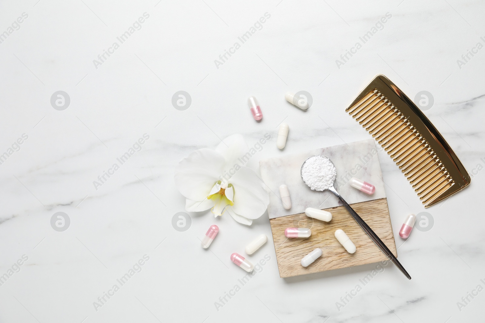 Collagen capsules, powder, comb and flower on white marble table, flat lay. Space for text Photo of Collagen capsules, powder, comb and flower on white marble table, flat lay. Space for text